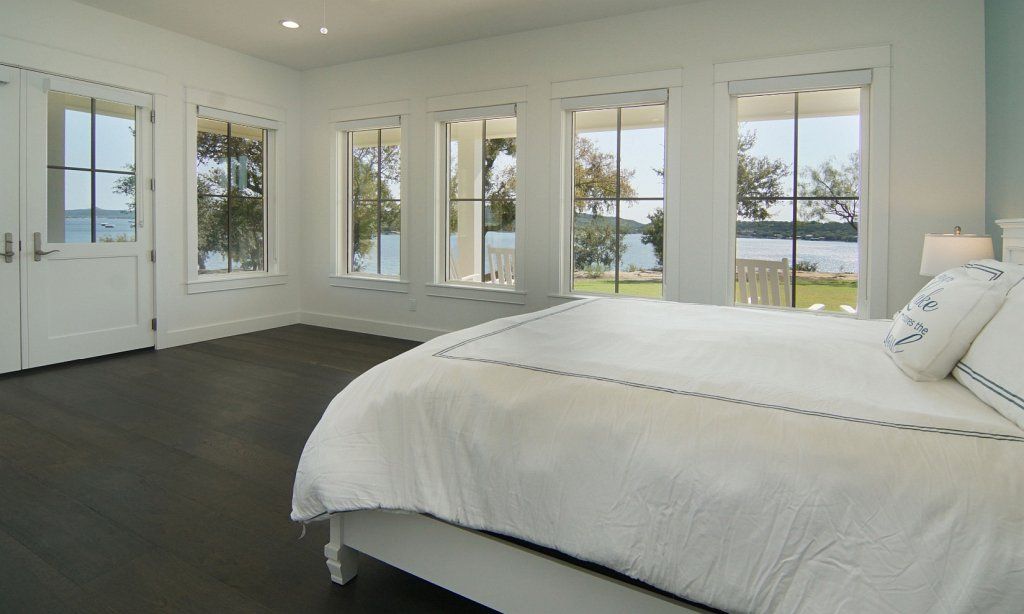 Bedroom with double-door patio access and many lovely windows