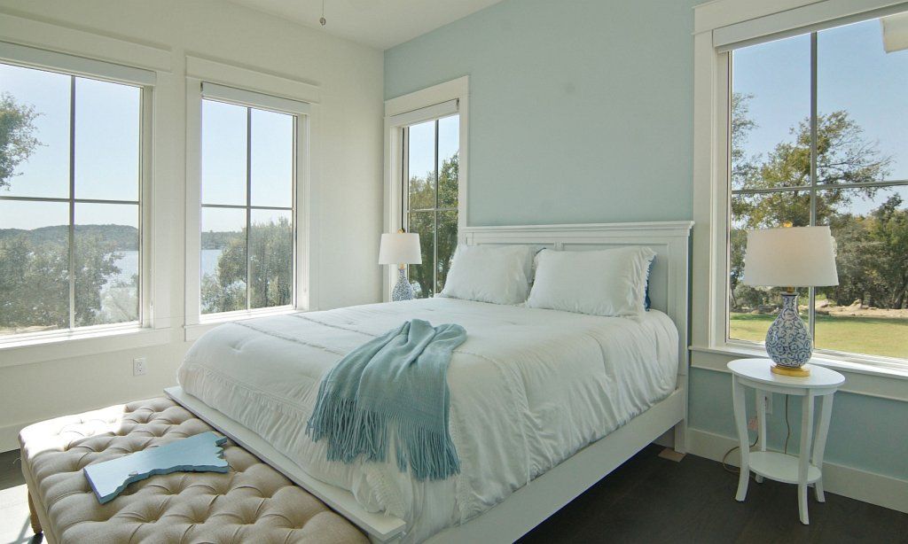 Bedroom with many windows and lake view